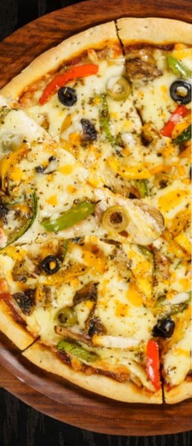 Wood-board pizza with olives and peppers